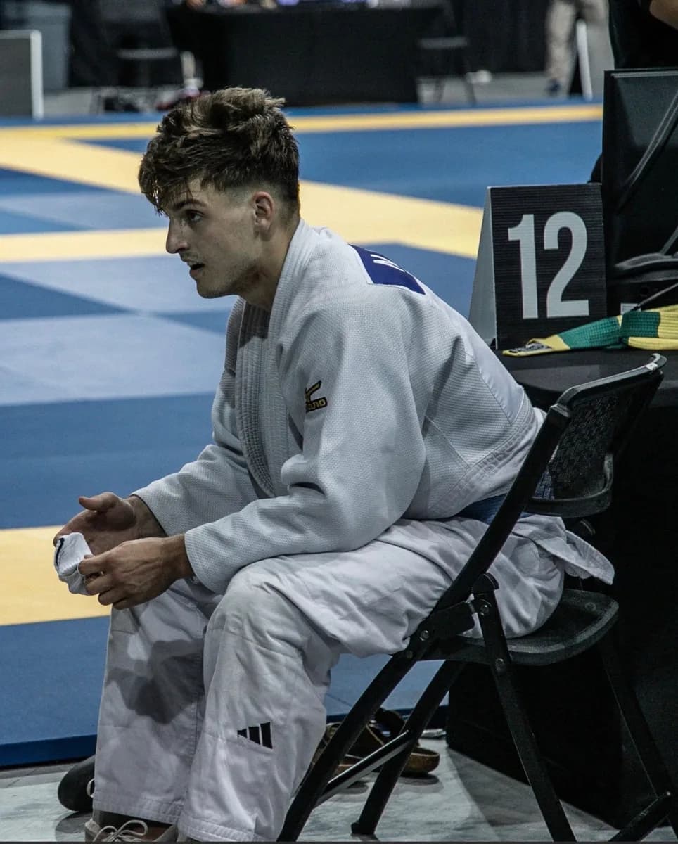 Nick Luchkin matside in his judo gi at a competition